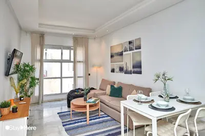 a living room with a couch and a table at Stayhere Rabat - Agdal 2 - Classic Residence in Rabat