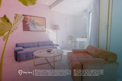 a living room with a couch and a table at Stayhere Rabat - Agdal 2 - Classic Residence in Rabat