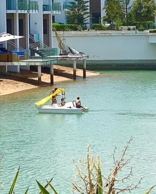 a group of people in a small boat in the water at Appt BOUZNIKA EDEN ISLAND pied sur Mer pour FAMILLE et Couple MARIE in Bouznika