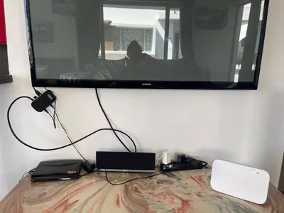 a flat screen tv hanging on a wall at Eden Island Apartment with a View in Sidi el Haj Bou Derbala