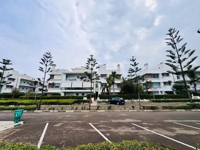 a parking lot in front of a large apartment complex at Eden Island Apartment with a View in Sidi el Haj Bou Derbala