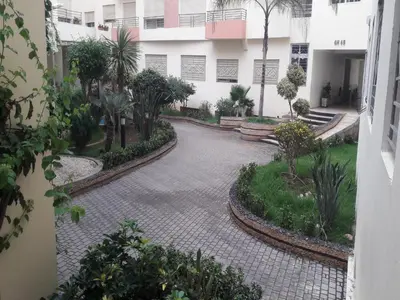 a courtyard with palm trees and a building at Apartment with Terrace in Casablanca