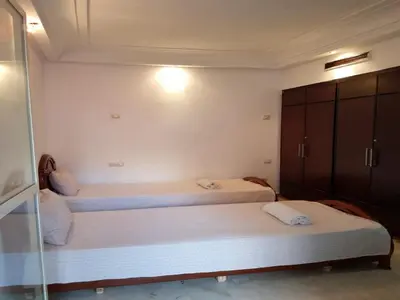 a bedroom with two beds and a glass wall at Apartment with Terrace in Casablanca
