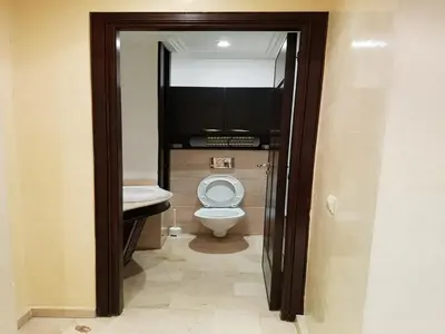 a bathroom with a toilet and a television in it at Apartment with Terrace in Casablanca