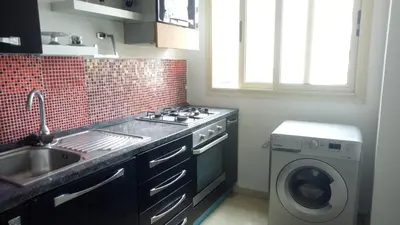 a kitchen with a sink and a washing machine at Apartment with Terrace in Casablanca
