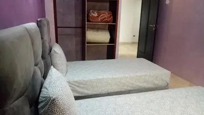 a bedroom with a couch and a bed and a closet at Apartment with Terrace in Casablanca