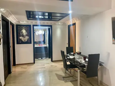 a dining room with a table and black chairs at Apartment with Terrace in Casablanca