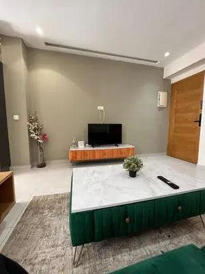 a living room with a tv and a couch at Luxury appartement in Heart of Casablanca Maarif in Casablanca