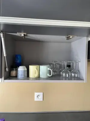 a shelf with pots and pans in a kitchen at Luxury appartement in Heart of Casablanca Maarif in Casablanca