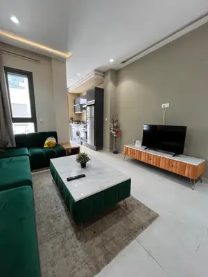 a living room with a green couch and a coffee table at Luxury appartement in Heart of Casablanca Maarif in Casablanca