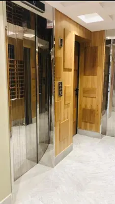 a hallway with glass and wooden doors in a building at Luxury appartement in Heart of Casablanca Maarif in Casablanca