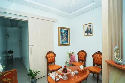 a dining room with a table and chairs at Hôtel Texuda in Rabat