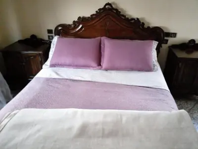 a bed with purple and white sheets and pillows at Maison vintage Rabat Agdal in Rabat