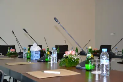 a long table with bottles and flowers on it at Flower Town Hotel & Spa in Rabat