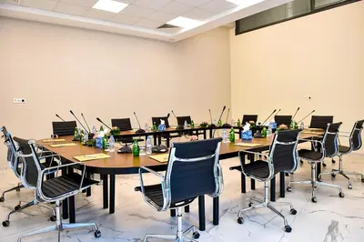 a conference room with a long table with laptops on it at Flower Town Hotel & Spa in Rabat