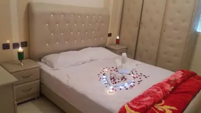 a bedroom with a bed with a heart with lights on it at Residence Bassatine in Temara