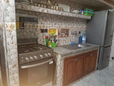 a small kitchen with a stove and a sink at Residence Bassatine in Temara
