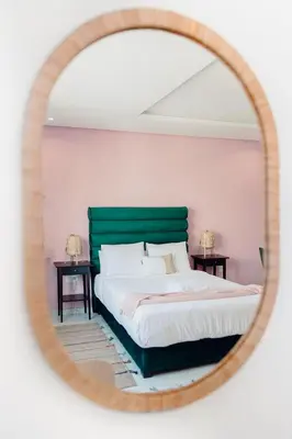 a bedroom with a large bed and a mirror at Stayhere Rabat - Agdal 1 - Comfort Residence in Rabat