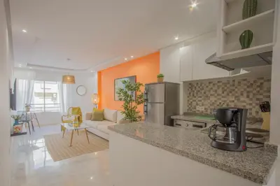 a kitchen with a counter top and a living room at Stayhere Rabat - Agdal 1 - Comfort Residence in Rabat