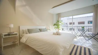 a bedroom with a white bed with a plant on it at Stayhere Rabat - Agdal 1 - Comfort Residence in Rabat