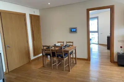 a dining room with a wooden table and chairs at Brand new, Stylish & Well located Apartment in Casa-Marina 12 in Casablanca