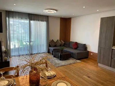 a living room with a couch and a table at Brand new, Stylish & Well located Apartment in Casa-Marina 12 in Casablanca