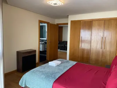 a bedroom with a bed and wooden cabinets at Brand new, Stylish & Well located Apartment in Casa-Marina 12 in Casablanca