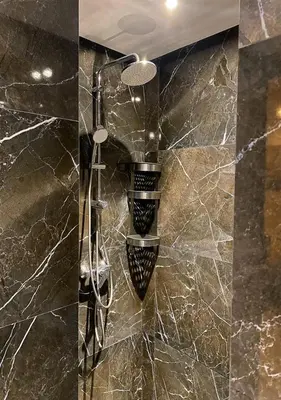 a shower in a bathroom with a marble wall at Amazing Flat in Gauthier - Breathtaking View - Best Location in Casablanca