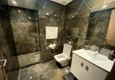 a bathroom with a toilet and a shower and a sink at Amazing Flat in Gauthier - Breathtaking View - Best Location in Casablanca
