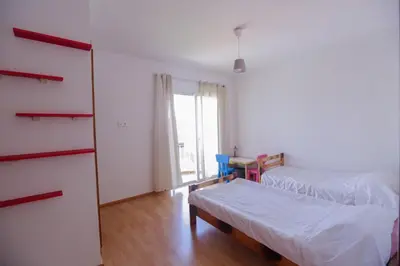 a bedroom with two beds and a window at Chez Didier Tamaris Beach in Dar Bouazza