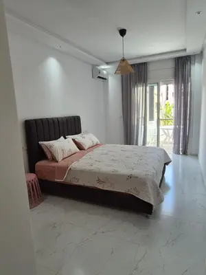 a bedroom with a large bed and a window at My Cosy Place Rabat - RABAT AGDAL GARE TGV ARRIBAT Center in Rabat