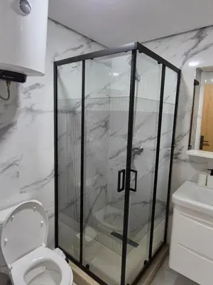 a bathroom with a shower with a toilet and a sink at My Cosy Place Rabat - RABAT AGDAL GARE TGV ARRIBAT Center in Rabat