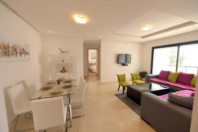 a living room with a couch and a table at Prestigia Rabat Hay Riad Premium Apartments in Rabat