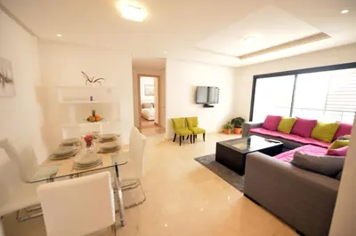 a living room with a couch and a table at Prestigia Rabat Hay Riad Premium Apartments in Rabat