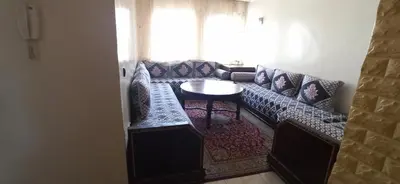 a living room with a couch and a table at Maison de la famille in Casablanca
