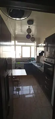 a kitchen with a table in the middle of it at Maison de la famille in Casablanca