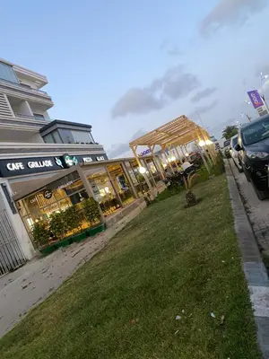 a group of buildings on a street with a grass field at Mansbay Beach, Vue sur Mer, accès Plage à pied, Mohammedia in Mohammedia