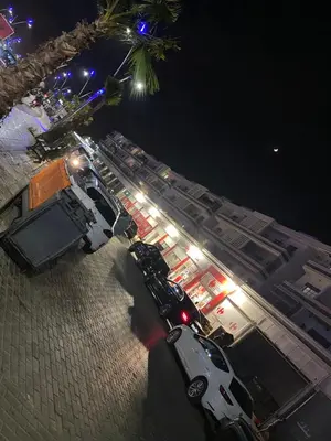 a parking lot at night with cars parked on the street at Mansbay Beach, Vue sur Mer, accès Plage à pied, Mohammedia in Mohammedia