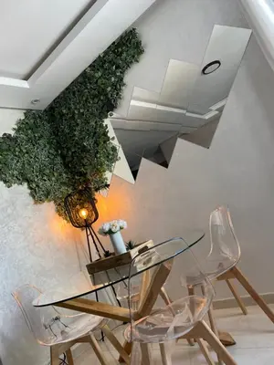 a dining room with a glass table and chairs at Mansbay Beach, Vue sur Mer, accès Plage à pied, Mohammedia in Mohammedia
