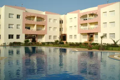 an empty swimming pool in front of buildings at L Appartement évasion in Mohammedia