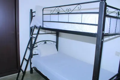 a bedroom with two bunk beds in a room at Les charmes de la Campagne de Bouznika in Bouznika