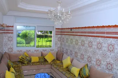 a living room with a couch and a chandelier at Mohammedia pour les vacances in Mohammedia