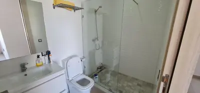 a bathroom with a shower and a toilet and a sink at Appartement neuf haut standing vue mer in Skhirat