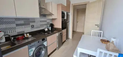 a kitchen with a sink and a stove top oven at Appartement neuf haut standing vue mer in Skhirat