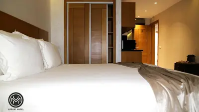 a large bed with white pillows in a hotel room at Maarif Home Casablanca in Casablanca