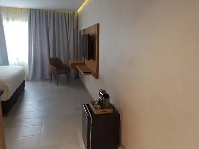 a hotel room with a bed and a television at Maarif Home Casablanca in Casablanca