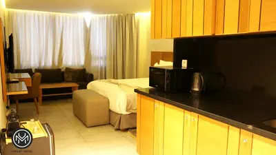 a hotel room with a bed and a living room at Maarif Home Casablanca in Casablanca