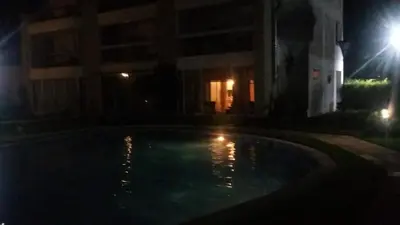 a swimming pool at night with a building at Appartement au Bord de la Mer in Casablanca