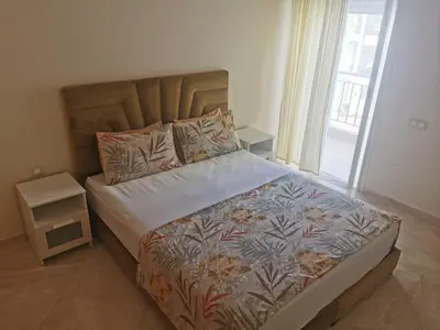 a bedroom with a large bed with a large window at Casabay Appart Vue Sur Piscine in Sidi Rahal
