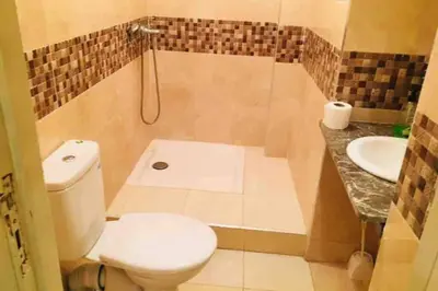a bathroom with a toilet and a sink at Nice 2 Bedrooms Apartment near the beach in Rabat